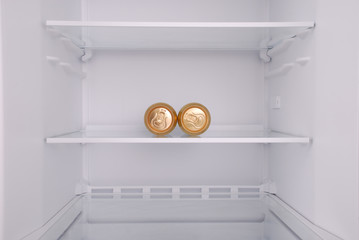Two metal beer cans inside in empty clean refrigerator © Akova