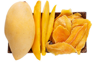 Dehydrated mango slices and fresh raw mango on wooden plate isolated on white. Dried fruits....