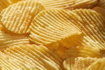 Close up potato chips top view food background.