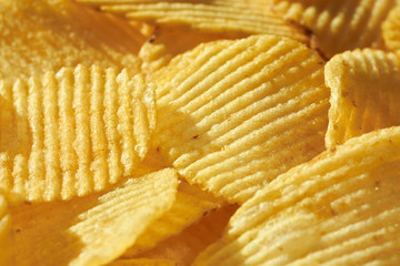 Close up potato chips top view food background.