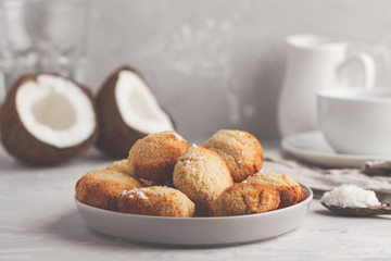 Healthy vegan homemade coconut cookies with tea/coffee, light background. Healthy vegan food concept.