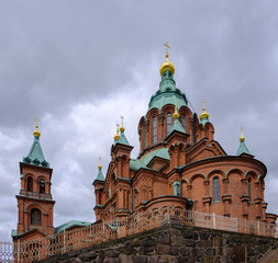 Fototapeta na wymiar Helsinki, Finland, Uspensky cathedral Helsinki on a background of a gray sky