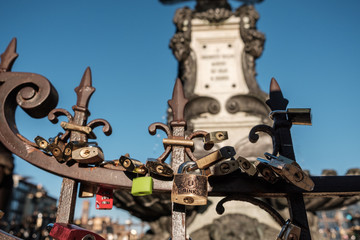 Fototapeta na wymiar Florence, Italy - 16 October 2017: Locks on the fence on the bridge Ponte Vecchio left by the newlyweds