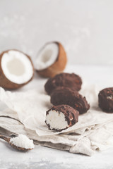Raw homemade vegan chocolate coconut dessert bounty, white background. Healthy vegan food concept.