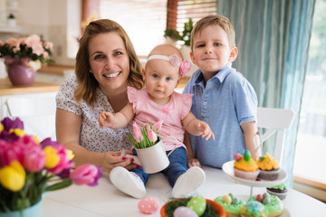 Happy and loving mother and her kids preparing home decoration