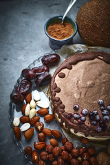 Chocolate vegan cake with different nuts, dates and carob