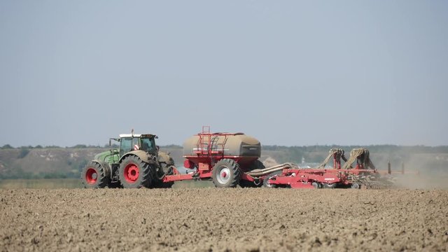 Image with Air Hot Temperature Reflections of a Tractor Plowing and Seeding