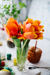 Blossoming red tulips on a white wooden background