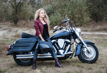 Plakat Biker woman outdoor with a motorcycle.