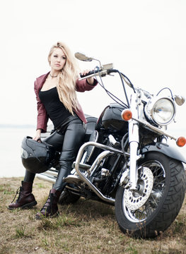Biker woman outdoor with a motorcycle.