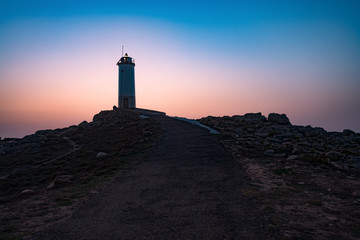 Fototapeta na wymiar Drone flying over Lighthouse during sun rise.