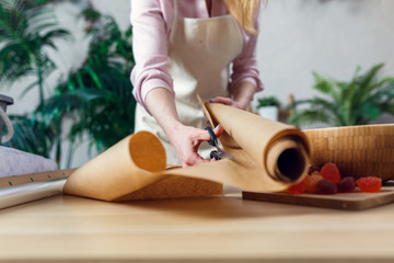 Female florist creating bouquet on the table.
