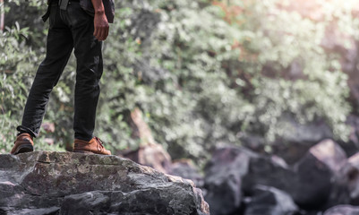 Tourist Man On The Rocks Near River Side. Hiking Destination Experience Lifestyle Concept