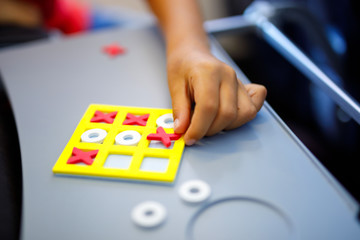 Tic tac toe game. Leisure activity for kids and adults. At home, traveling, on plane.