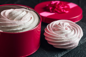 Raspberry meringue on concrete desk. Space for text. Close up view. Romatic wedding. 