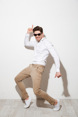 Full length portrait of a joyful young man