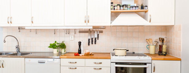 header of a kitchen counter top with sliced white bread, fresh herbs and tomatoes