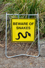 Yellow beware of snakes warning sign in suburban Melbourne.