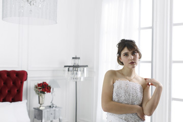 Obraz na płótnie Canvas Young beautiful girl in a bride's dress