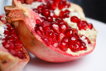  fresh pomegranate in a cut on a white plate