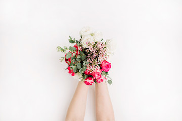Woman hands hold bouquet of roses, eucalyptus branch, wildflowers. Flat lay, top view wedding background concept.
