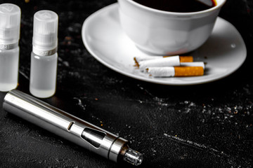 elimination of tobacco smoking electronic cigarette on dark back