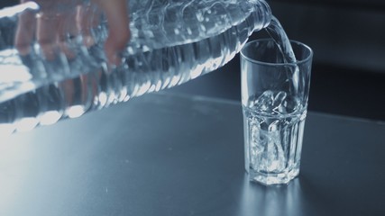 closeup slowmotion of glass fulling with water bubble floating