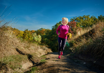 Fitness woman with resistance rope training on fresh air