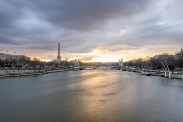 Long exposure of amazing sunset in Paris, with Seine river, Pont Alexandre III and Eiffel tower