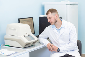 Research or genetics scientist using laptop in medical office or laboratory.