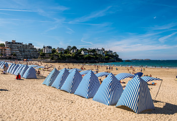 Beach in with striped tents Dinard, Brittany, France - obrazy, fototapety, plakaty