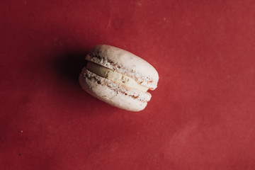 Delicious macaroon on red table, sweet dessert