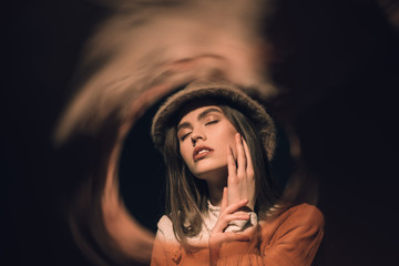 portrait of fashionable woman in hat with eyes closed