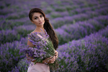 Walking women in the field of lavender.Romantic women in lavender fields. Girl admires the sunset in lavender fields.