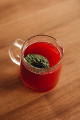 Delicious fresh gaspacho in glass mug on wooden table