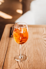 Delicious cocktail with ice cubes on wooden table