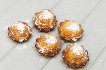 Delicious sweet cupcakes on white wooden table, delicious homemade dessert