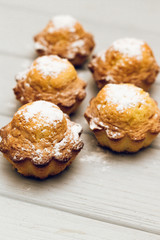 Delicious sweet cupcakes on white wooden table, delicious homemade dessert