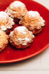 Delicious sweet cupcakes on red plate, delicious homemade dessert