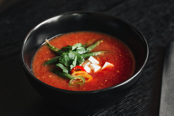 Delicious tomato soup with parsley and pepper