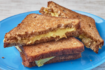Grilled sandwich with cheese on a plate.