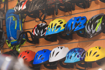 various colorful helmets displayed in bicycle shop