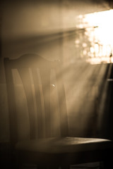 Wood dinner chair in house and sunlight on sunset.