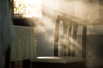 Wood dinner chair in house and sunlight on sunset.