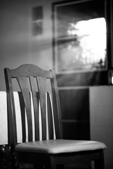 Black and white wood dinner chair in house and sunlight on sunset.