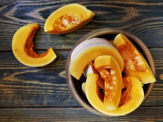 sliced pumpkin on a wooden Board and the old background