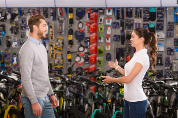 Fototapeta na wymiar side view of seller and customer talking in bicycle shop