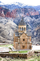 Medieval armenian Noravank monastery complex against red mountains, Armenia