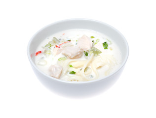 Bowl of thick chicken soup over white background