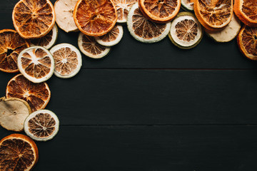 Frame of dry fruits slices on black background